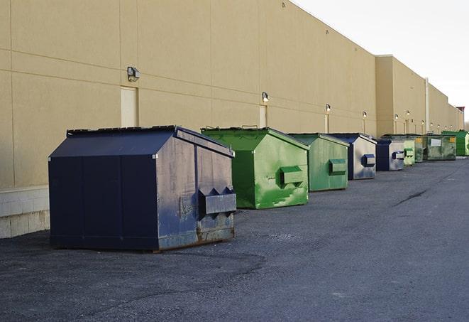 a row of large construction dumpsters on-site in Akron